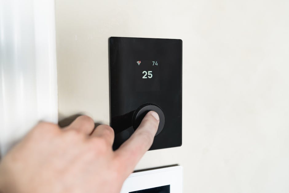 Homeowner adjusting a smart thermostat on the wall