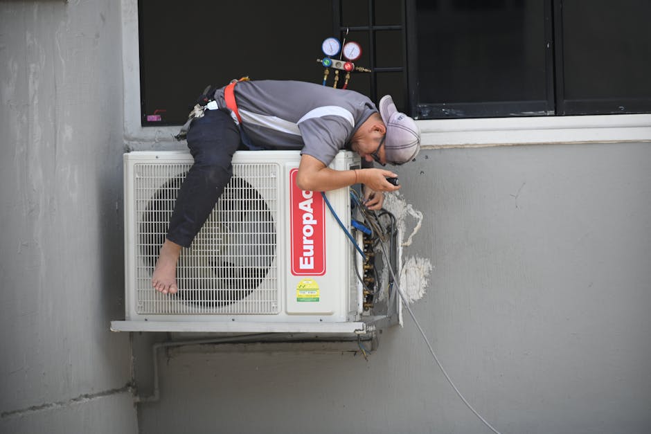 HVAC technician working on an outdoor air conditioning unit